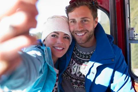 Couple talking selfie in ski lift Stock Photos