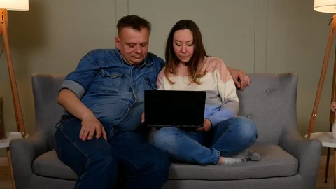 Couple talking to someone on video chat on laptop Stock-Footage 126852438