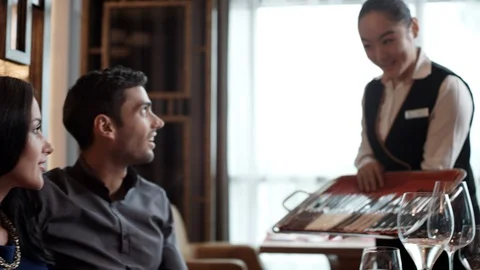 Couple talking with waitress at restaurant. Stock Footage 119376879