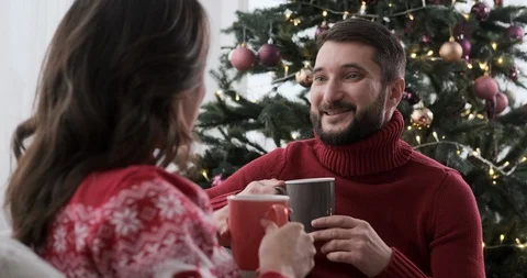 Couple talking while drinking coffee in living room Video stock 129424692