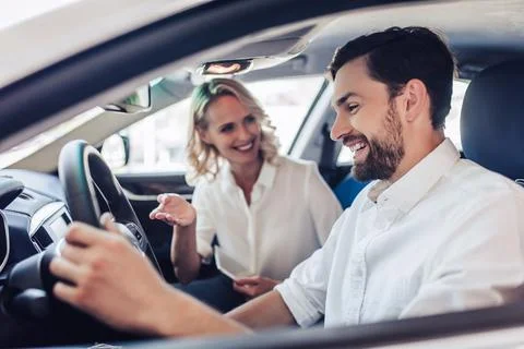 Couple talking while driving a car Stock Photos