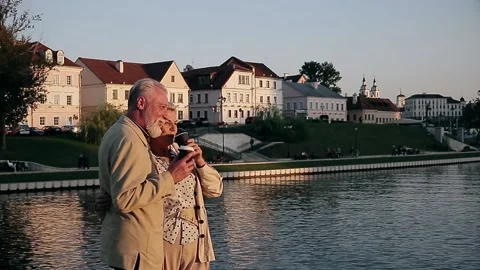 Couple talking while holding disposable coffee cup at embankment Stock Footage 168911058