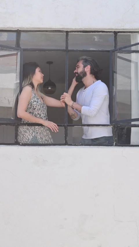 Couple talking at the window, video from outside the building. Stock Footage 135705508