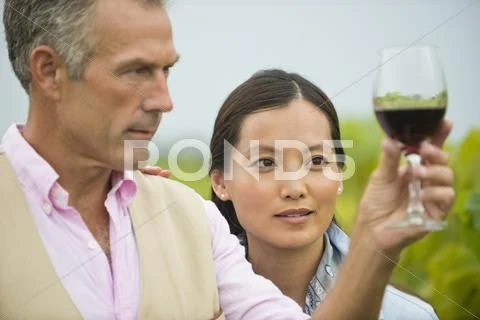 Couple tasting wine together in vineyard Stock Photos