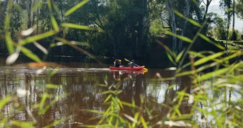 Couple, teamwork and rowing in kayak on lake on holiday, vacation and travel Stock Footage 254963724