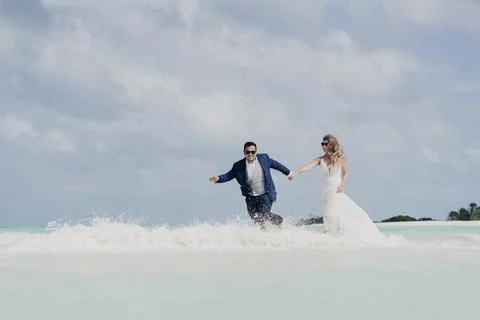 Couple on their wedding day doing a session on the shore of the Caribbean Sea Stock Photos
