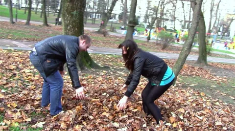 Couple throwing leaves Stock Footage 55483440