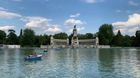 Couple in a tiny boat at big pond in the Buen Retiro Park. Madrid, Spain Stock Footage 218251113