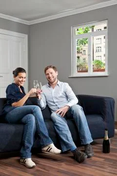 A couple toasting champagne flutes at home Stock Photos