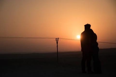 Couple together with sunset at the background Stock Photos