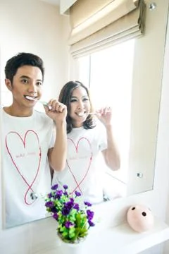 Couple with toothbrushes Stock Photos