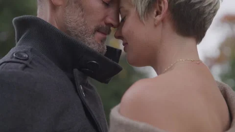 Couple Touch Faces While Embracing Each Other Outside 库存影片 208724211