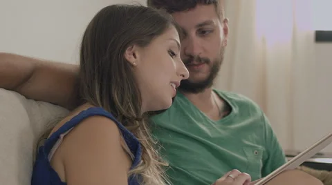 Couple touching the tablet to watch shows and movies on the Internet Stock Footage 59325841