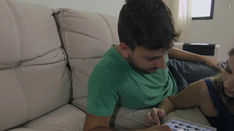 Couple touching the tablet to watch shows and movies on the Internet 動画素材 59326929