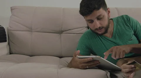 Couple touching the tablet to watch shows and movies on the Internet Video stock 59328230