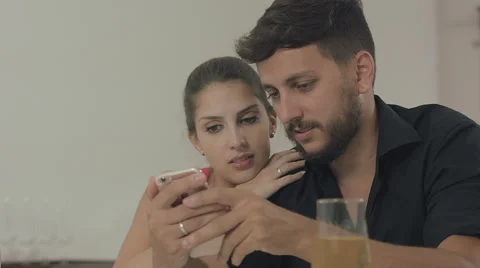 Couple touching the tablet to watch shows and movies on the Internet Video stock 59329628