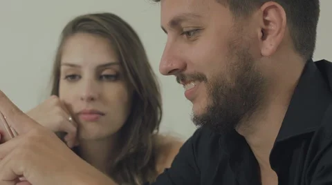 Couple touching the tablet to watch shows and movies on the Internet Stock Footage 59329697