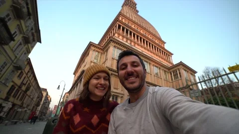 Couple tourist  taking selfie with Mole Antonelliana in Turin (torino) city Stock Footage