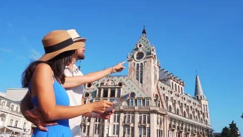 Couple of tourists having fun walking in Batumi city street on holiday - Ha.. Видео 332117293