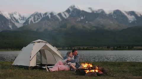A couple of tourists sit by the fire in the evening. Stock Footage 280887585