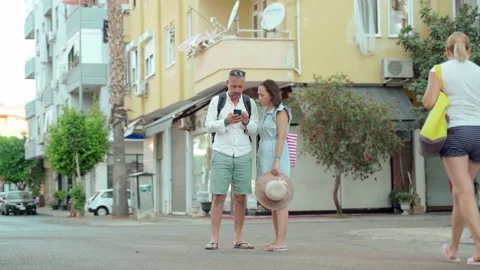 Couple of tourists using smart phone gps in street search locations. A woman Stock Footage 165417679