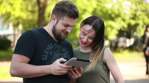 Couple in town connected on digital tablet Stock Footage 50981458