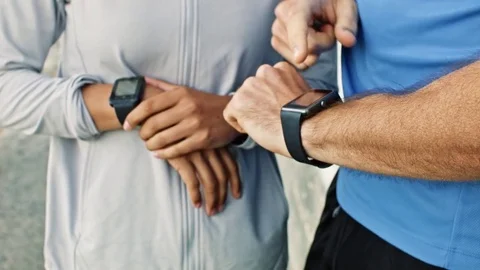 Couple tracks exercise stats on wearable technology Stock Footage 76521690