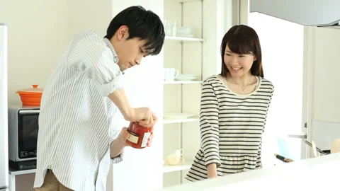 Couple trying to open a jar lid in the kitchen Stock Footage 159805513
