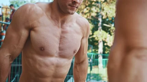 Couple of two athletes exercising pull-ups on parallel bars face to face Video stock 148971586