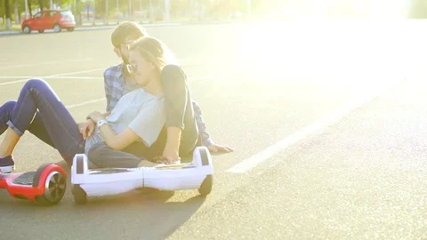 Couple with two hover boards relaxing Vídeos de archivo 74691333