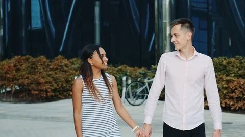 Couple of two mixed-race young people having a date in the city center Video stock 119424192