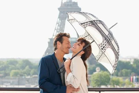 Couple under an umbrella with the Eiffel Tower in the background, Paris, Stock Photos