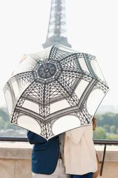 Couple under an umbrella with the Eiffel Tower in the background, Paris, Stock Photos