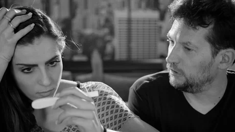 Couple unhappy about negative pregnancy test result black and white Stock Footage 71241296