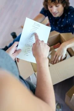 Couple unpacking moving boxes Stock Photos