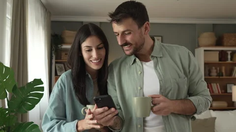 Couple use mobile phone for text message or browse internet at home Stock Footage 279780192