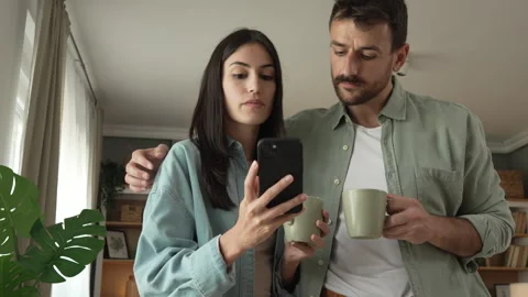 Couple use mobile phone for text message or browse internet at home Stock Footage 279780198