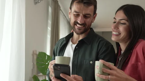 Couple use mobile phone for text message or browse internet at home Video stock 279780221