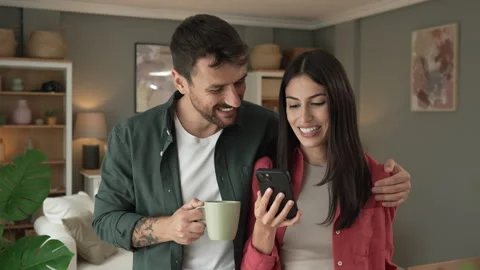 Couple use mobile phone for text message or browse internet at home Stock Footage 279780278