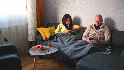 Couple Use Smartphone Device, Sitting on Couch Cozy Apartment. Boyfriend an.. Stock Footage 226278257