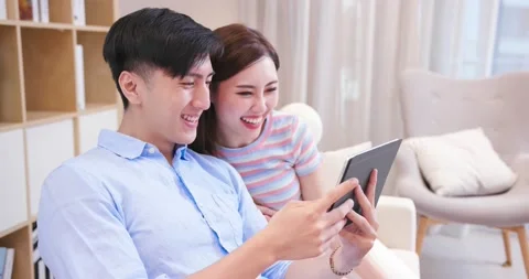 Couple use tablet at home Video stock 137014592