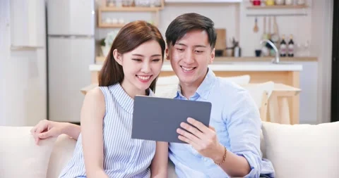 Couple use tablet at home Stock Footage 137625526