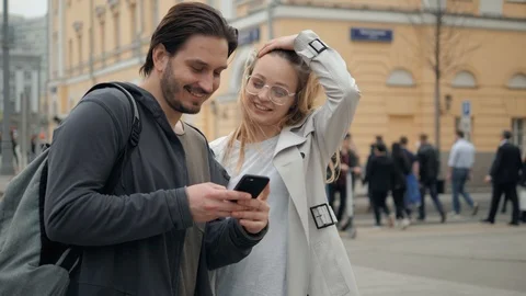 Couple using cell phone or tablet computer at outdoor, man and woman use phone Stock Footage 89498567