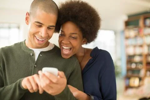 Couple using cell phone together Stock Photos