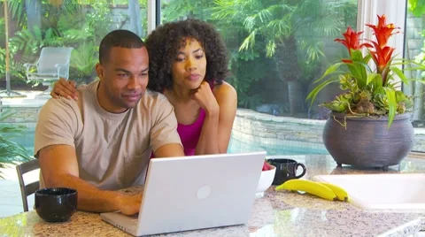 Couple using computer at kitchen counter Stock-Footage 7730446