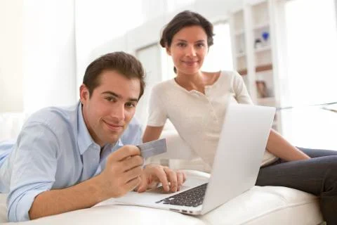 Couple using credit card to shop online Stock Photos
