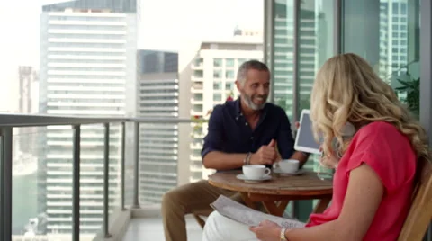 Couple using digital tablet and newspaper at balcony. Stock Footage 64119627