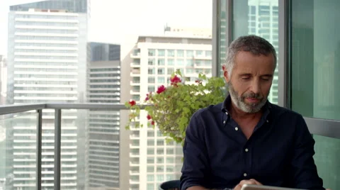 Couple using digital tablet and newspaper at balcony. Stock Footage 64119798