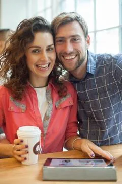 Couple using digital tablet in cafe, portrait Stock Photos