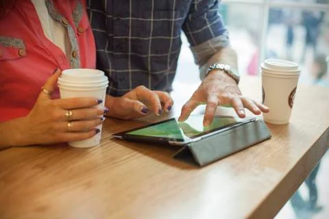 Couple using digital tablet in coffee shop, cropped 스톡 사진